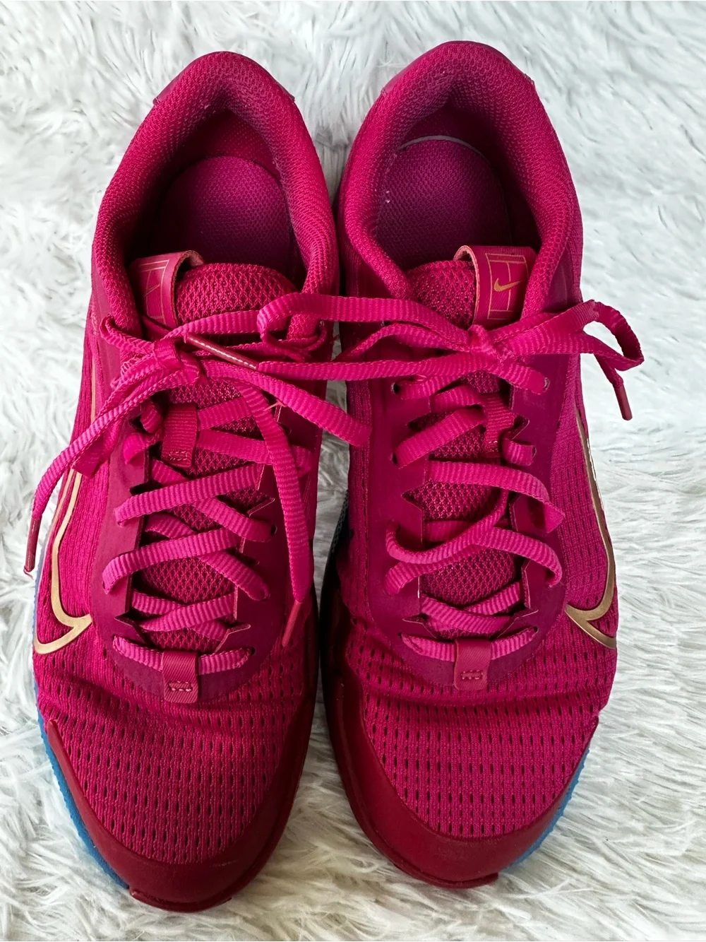 Nike Women's Bold Pink Athletic Court Shoes with Teal Purple Gradient Accent.